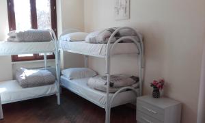 a room with three bunk beds with pillows on them at Villa Luzzatti in Rome