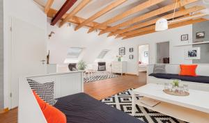a living room with white walls and wooden ceilings at Hotel Rutherbach in Essen
