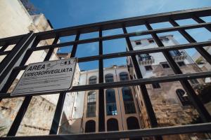 a sign on a gate in front of a building at GRAN CANCELLIERE Apartments in Palermo