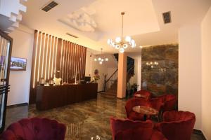 a lobby with red chairs and a bar at Elite in Pogradec