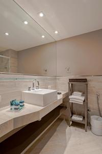 a bathroom with a sink and a large mirror at Slaviero Hotel Baia Norte Florianópolis in Florianópolis