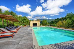 a pool at a villa with lounge chairs at Villa Casentino by PosarelliVillas in Capolona