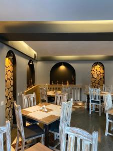 a dining room with wooden tables and chairs at Roberto Hotel in Sinaia