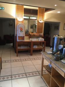 a room with a counter and a room with tables at Kyriad Rodez in Rodez