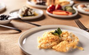 a white plate of food on a table at Burgi's - Adults only in Lech am Arlberg