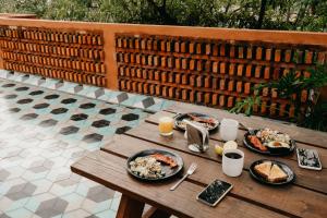 a wooden table with plates of food on it at Hostal Hidalgo in Guadalajara