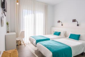 Postel nebo postele na pokoji v ubytování Hostal La Isla
