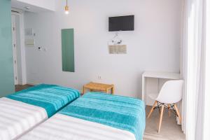Postel nebo postele na pokoji v ubytování Hostal La Isla