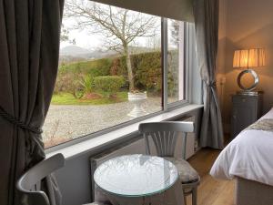 a room with a table and a window at River Meadows B&B in Kenmare