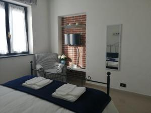a bedroom with a bed with two towels on it at Lucky House in La Spezia