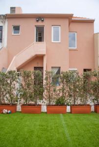 a house with a lawn in front of it at Espinho Guesthouse - Garden House in Espinho +28 photos