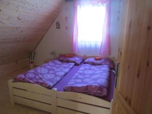 a bedroom with two beds in a attic at Rekreační dům v Brdech Pod Svatou Annou in Ohrazenice