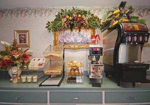 a counter top with a coffee maker and food on it at Key West Inn - Montgomery South in Montgomery