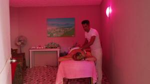 un hombre de pie junto a una mujer en una habitación rosa en Yucesan Hotel, en Avsallar