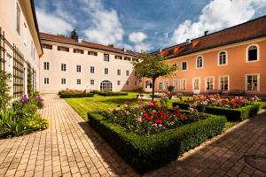 a courtyard with flowers in front of a building at Hotel Schloss Leopoldskron in Salzburg