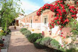 a building with a wreath of red flowers on it at Hotel Villa Sevasti in Katerini