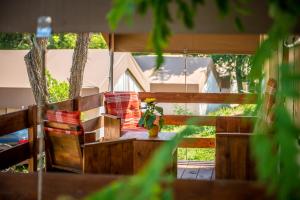 a porch with a bench and a table with a plant at Sunflower Camping in Novigrad Istria