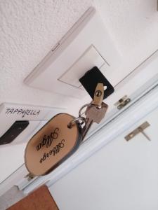 a couple of padlocks hanging from a ceiling at Hotel Alga in Bellaria-Igea Marina