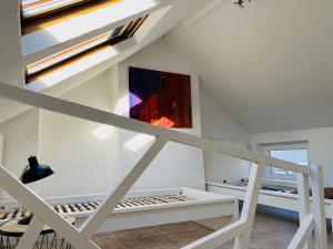 a room with white walls and a ceiling with a window at Roture 88 in Liège