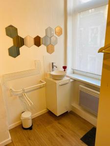 a small bathroom with a sink and a window at Roture 88 in Liège