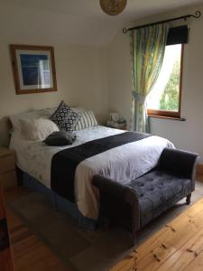 a bedroom with a bed with a cat laying on it at Caragh Glen B&B in Killorglin
