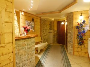 a hallway in a house with a stone wall at Willa Rosa in Szczyrk