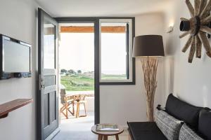 a living room with a couch and a window at Almyra Guest Houses in Paraga