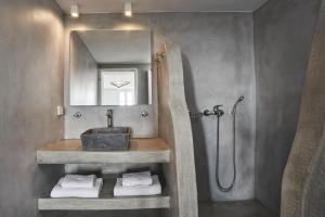 a bathroom with a sink and a shower at Almyra Guest Houses in Paraga