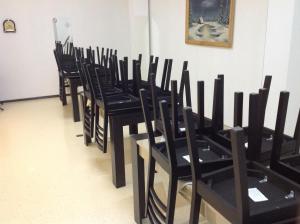 a row of black chairs sitting in a room at Pensiunea Alexandra Livia in Borşa
