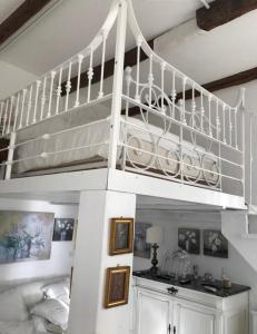 a white loft bed in a room with a bedroom at Maison Menton in Menton