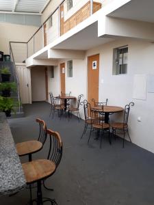 a group of tables and chairs in a room at FlatsCidade in Passos