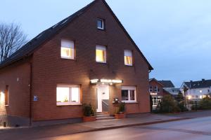 a red brick house with a white door at Schiller Pension in Bielefeld