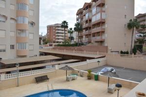 a view of a building with a pool and buildings at Arenales Beach in Arenales del Sol