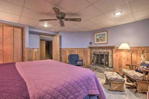 a bedroom with a large bed and a fireplace at Great Bear Lake Home with Private Dock and Fire Pit! in Grand Junction