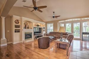 a living room with leather furniture and a fireplace at Luxury Palm Coast Home with Dock and Game Room! in Palm Coast