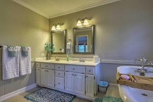 a bathroom with two sinks and a mirror and a tub at Updated Cabin on White River by Boat Landing! in Calico Rock +24 photos