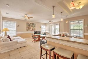 a large living room with a kitchen and a living room at Luxury Palm Coast Home with Dock and Game Room! in Palm Coast