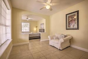 a living room with a ceiling fan and a couch at Luxury Palm Coast Home with Dock and Game Room! in Palm Coast +35 photos