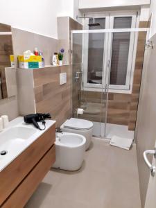 a bathroom with a toilet and a sink and a shower at Suite Rent Milan 2 in Milan +32 photos
