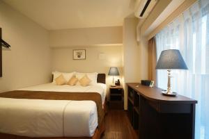 Postel nebo postele na pokoji v ubytování Le Tour Hotel Akihabara Ekimae 楽途ホテル秋葉原駅前店