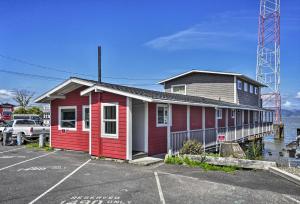 a red and white building next to a parking lot at Waterfront Condo on Pier in Downtown Astoria! in Astoria, Oregon
