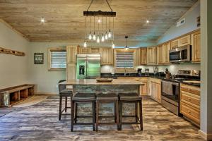 a kitchen with wooden cabinets and a green refrigerator at Secluded Cabin with Hot Tub, 3 Mi to Pigeon Forge! in Sevierville