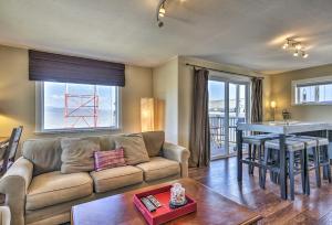 a living room with a couch and a table at Waterfront Condo on Pier in Downtown Astoria! in Astoria, Oregon