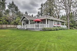a house with a large yard in front of it at Contemporary Tacoma Cottage with Deck and Pond! in Tacoma