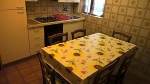 una cucina con tavolo e girasoli di appartamento vicino al mare per 4 persone a Viareggio a Viareggio