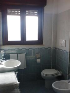 a bathroom with a toilet and a sink at Hotel Piper & River in Montesilvano