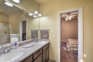 a bathroom with two sinks and a large mirror at Bentonville Home with Pool Table, 2 Mi to Downtown! in Bentonville +33 photos