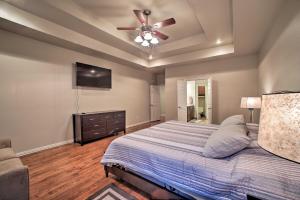 a bedroom with a bed and a ceiling fan at Bentonville Home with Pool Table, 2 Mi to Downtown! in Bentonville
