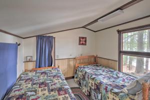 A bed or beds in a room at Lakefront Hartford Cabin with Canoe and Boat Ramp