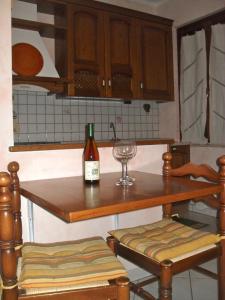 a bottle of wine sitting on a table in a kitchen at Affittacamere Casa Sofia in Anghiari +6 photos